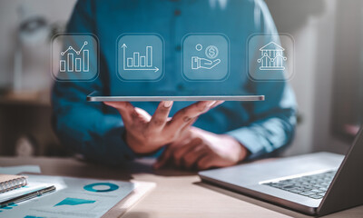 analyst, chart, diagram, graph, management, performance, plan, strategy, statistics, solution. A man is holding a tablet with a blue screen that has four different graphs on it.