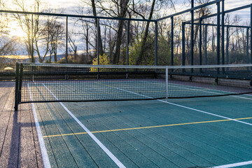 Elevated Platform Tennis, Paddle Ball courts with yellow pickelball lines, net and chicken wire...