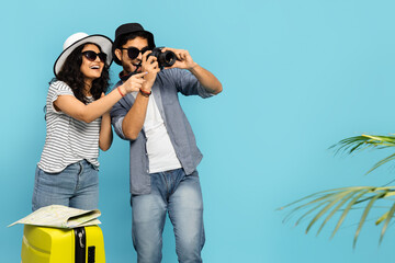 Happy Tourist Couple Smiling And Capturing Memories With A Camera On Their Summer Adventure. Travel...