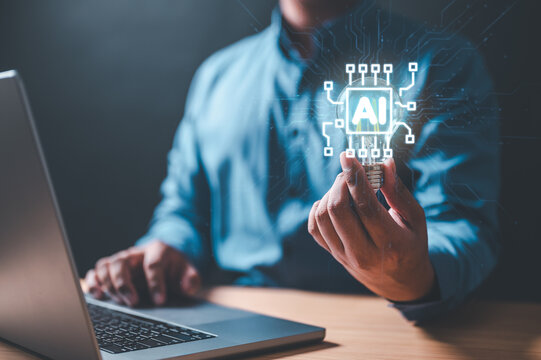 ai, artificial intelligence, innovation, intelligence, system, diagram, future, marketing, strategy, learning. A man is holding a laptop with a that has a picture of a brain with a light bulb on it.