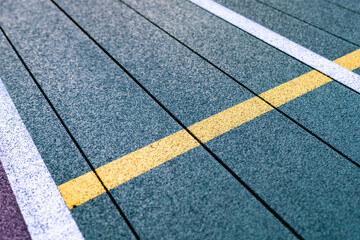 Fototapeta premium Elevated Platform Tennis, Paddle Ball courts with yellow pickelball lines. Floor surface is green with white and yellow 