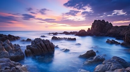 Fototapeta na wymiar Vertical long exposure shot of the seascape in guernsey during sunset