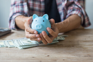 Hand holding piggy bank,saving concept,soft focus.