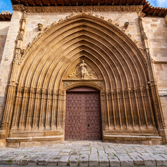 Medieval church facade highly decorated with stone carvings in Aranda de Duero, Burgos - obrazy, fototapety, plakaty
