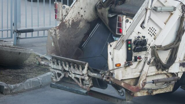 Garbage truck remove waste from city street. Collection and transportation of domestic garbage by municipal service.