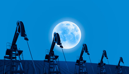 Oil beam pump or Oil pumps with full moon at night -  Oil industry equipment at sunset  