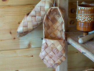 Woven bast shoes made of birch bark. Rustic shoes that people used to wear in the past. The...