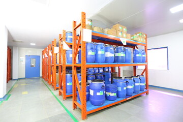 full warehouse filled with pharma blue container rack for storage and epoxy flooring in a...