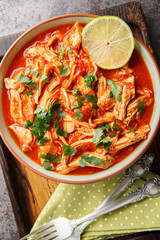 Salsa chicken combines taco seasoned chicken breasts with tomato salsa close-up in a bowl on a...