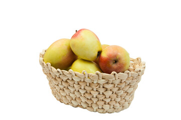 redsided apples in a wicker basket on a white background. sweet yellow apples on a light texture	