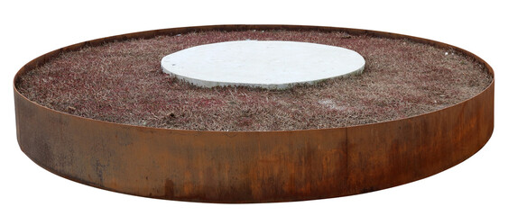 Rusty round iron flower bed with dry grass isolated