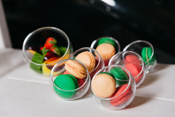 Assorted Macarons personal portions in Glasses. A delightful arrangement of colorful macarons and...