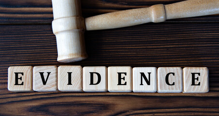 EVIDENCE - word on wooden cubes on background of judge's gavel