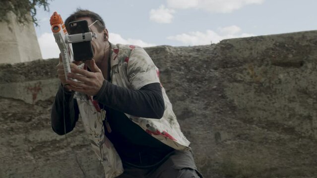Messy man shooting laster gun toy - steady cam 