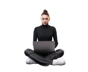 A young woman sits cross-legged using a laptop, isolated on a white background, depicting the concept of modern work flexibility