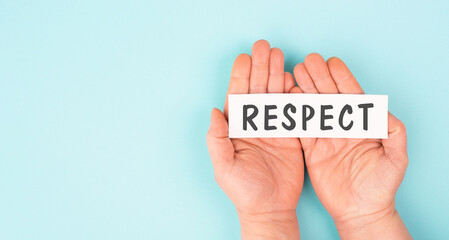 The word respect is standing on a paper, responsibility, tolerance and development, human relationship and interaction, inclusion and diversity