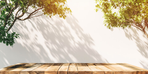 Empty wooden table over white wall background with green tree branches - 778014313