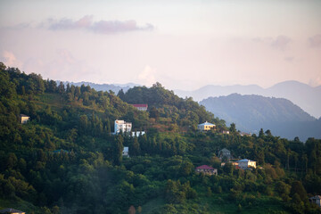 Fototapeta na wymiar Mountain landscape with houses at sunset.
