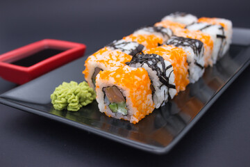 Sushi Composition with Soy Sauce and Wasabi on Dark Background