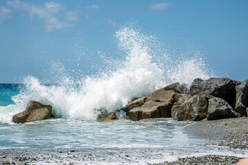 High wave breaking on the rocks of the coastline.