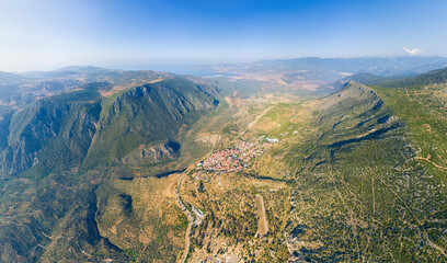 Delphi, Greece. Ruins of the ancient city of Delphi and the modern city. View of the valley. Sunny weather, Summer morning. Aerial view