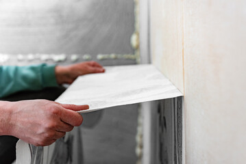 Removing old wallpaper from the wall.