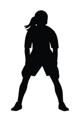 Black silhouette of a teenage girl goalkeeper of junior women's football teem in gloves who stands upright in goal and waits for the ball
