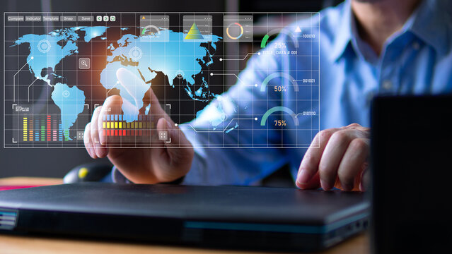 Businessman touch the global map on virtual screen checking business growing each location. Laptops on wood table in office room, business chart and graph analysis concept.