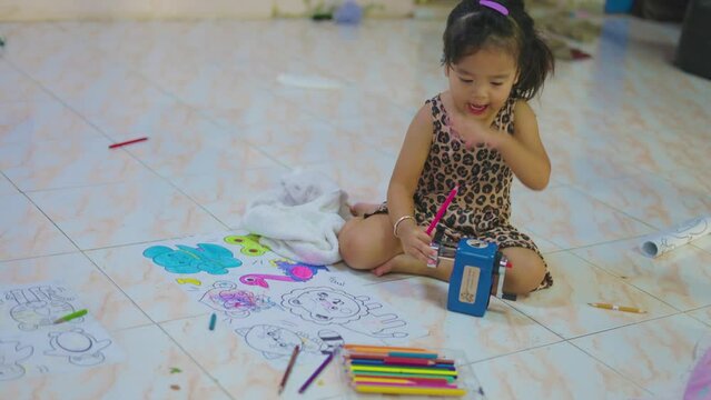Adorable little asian boy and girl drawing color on paper in cozy house kindergarten child learnning activity