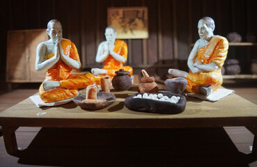 Model of Monks recite mantras for making medicine. Thai ancient compound medicine room.