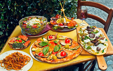 A summer  dinner .Traditional italian food in outdoor restaurant in Trastevere district in Rome, Italy.Tasty and authentic Italian kitchen - 778080598