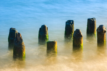 Seascape. Breakwater in the sun. Leba. Baltic Sea. Poland.