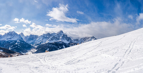 Fototapeta na wymiar Wide panoramic view of winter landscape with snow covered Dolomites in Kronplatz, Italy