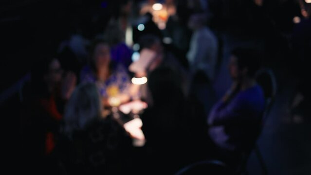 Bar rendezvous: Group of friends seated in a bar, sipping drinks and engaging in animated conversation