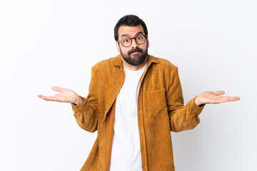 Caucasian handsome man with beard wearing a corduroy jacket over isolated white background having...