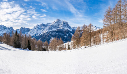 Wide panoramic view of winter landscape with snow covered Dolomites in Kronplatz, Italy
