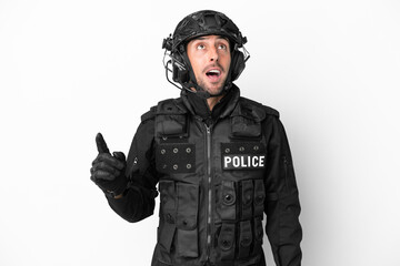 SWAT caucasian man isolated on white background pointing up and surprised