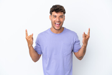 Young caucasian handsome man isolated on white background making horn gesture