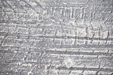 Tyre mark texture. Tire track on the road background. Melt asphalt imprint. Highway damaged with...