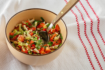 prepeared at home vitamin vegetable salad in ceramic bowl close up
