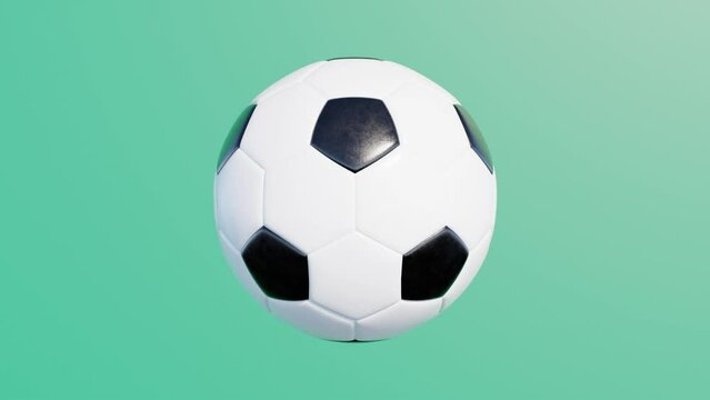 Soccer ball rotates on a green background. Simple 3d object animation. Realistic sport equipment render