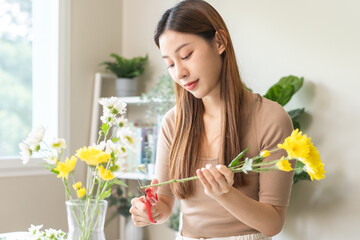 Flower arrangement, close up hand of asian young woman florist making flower in vase, creating...