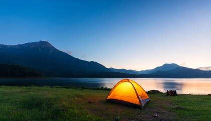 morning twilight scene of mountain with camping tent and light up at the lake shore