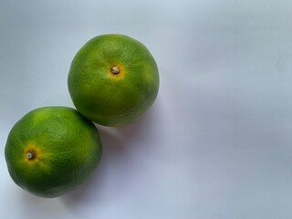 tangerine, orange with green, on a light background texture, isolation