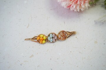 Colorful hair clips on a white background, with a flower. Top view.