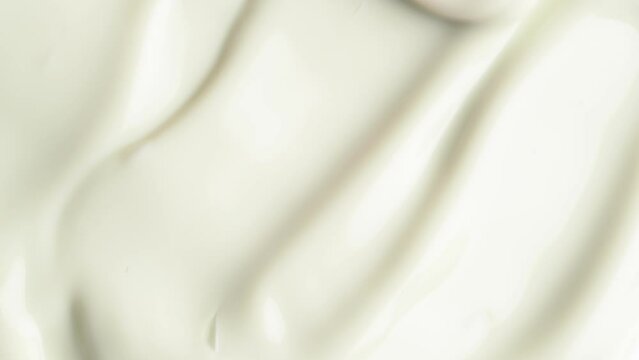 Moisturising creme swatch motion with spatula. Cosmetic texture of anti-cellulite cream for body, macro shot.