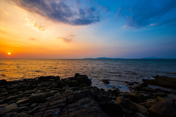 Two color of sunset sky. Blue and orange color sky at evening or sunset time over sea water.