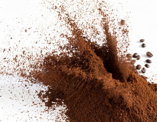 Coffee powder burst from coffee bean isolated on white background.