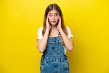 Young caucasian woman isolated on yellow background frustrated and covering ears - 778128773