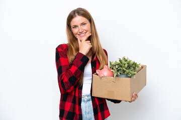 Young caucasian woman making a move while picking up a box full of things isolated on white...